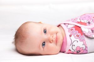 Cute baby girl lying on her back